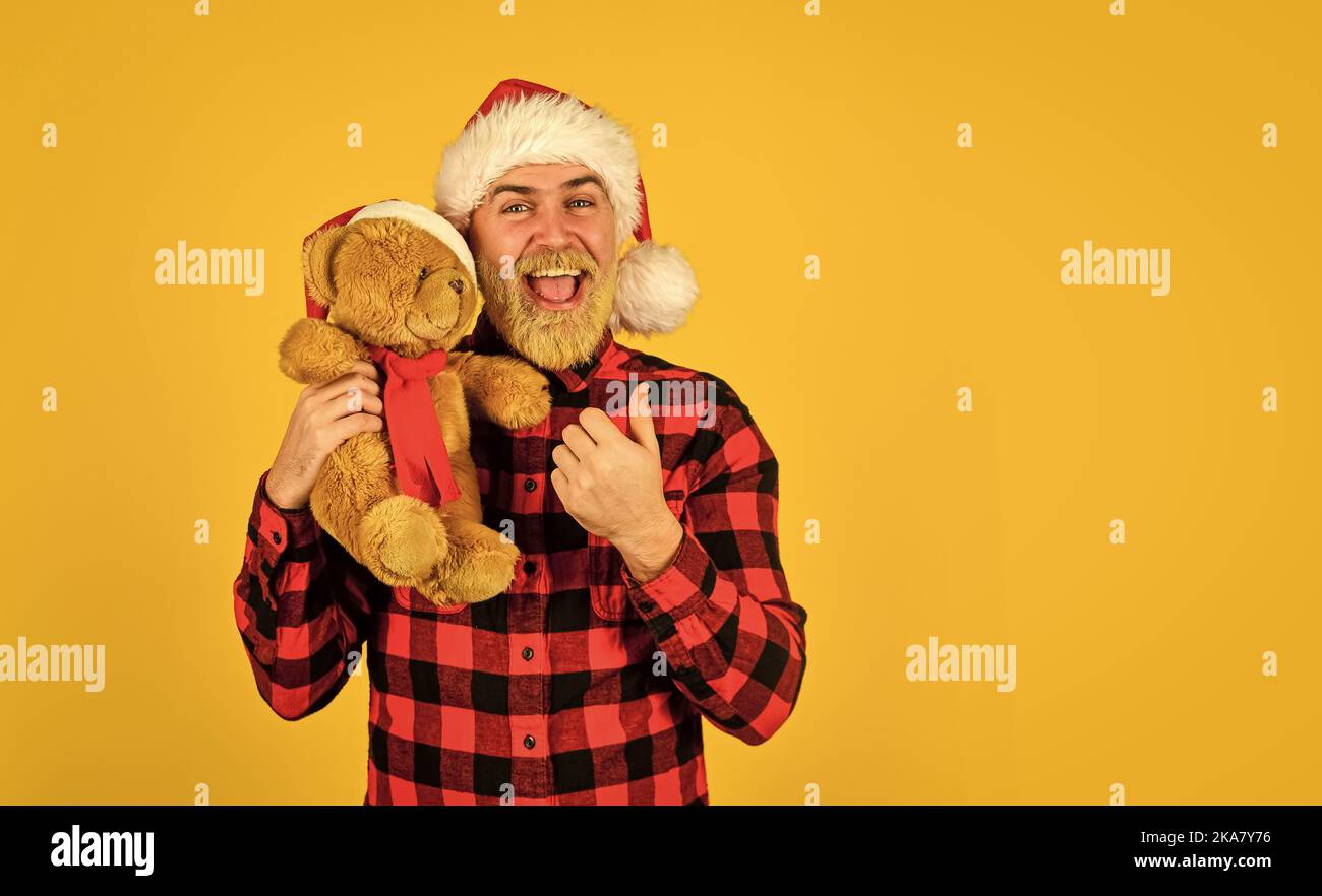 Christmas time for mercy. Charity project. Bearded man celebrate christmas. Kind hipster with teddy bear. Charity and kindness. Lovely hug. Santa Stock Photo