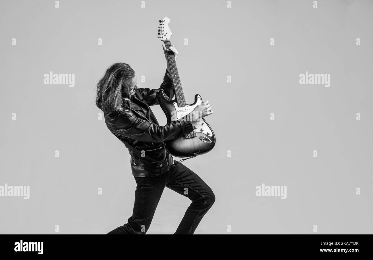 musician guitar player. masterfully playing rock music. stylish crazy
