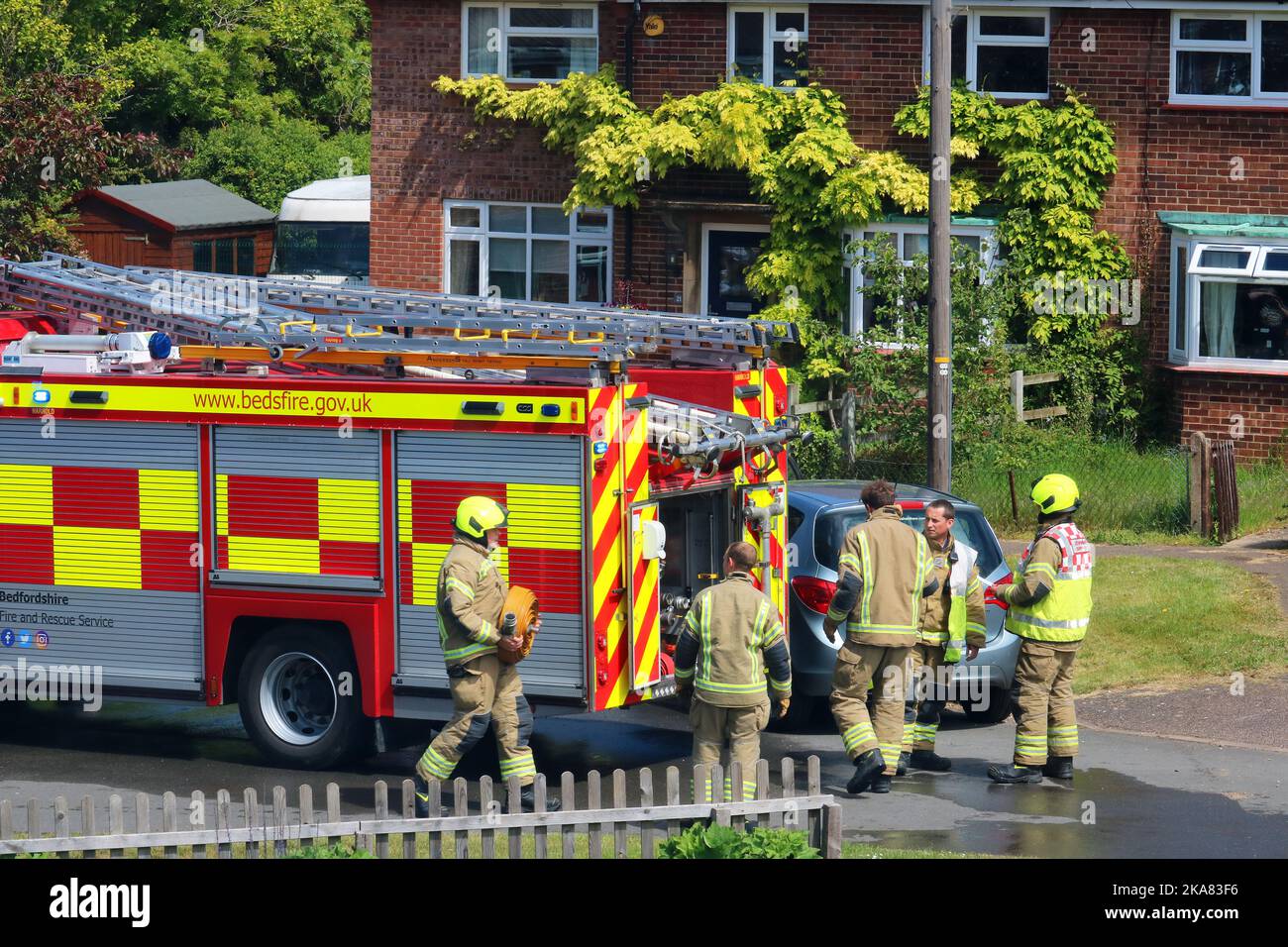 Firemen attending a a small fire in Bedfordshire, United, Kingdom. Stock Photo