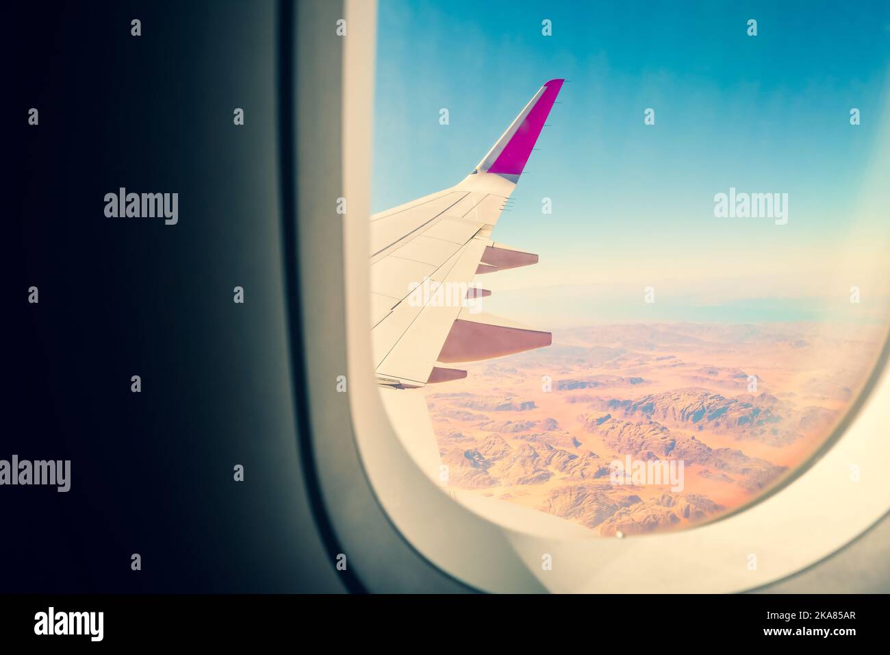 Cinematic copy space travel Airplane window view to amazing landscape of wadi rum desert in Jordan middle east. Concept of travel and air transportati Stock Photo