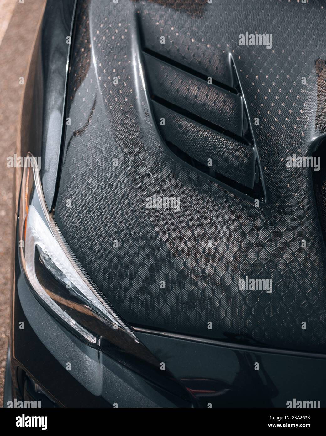 A vertical shot of Subaru WRX STI Carbon Fiber hood pattern Stock Photo