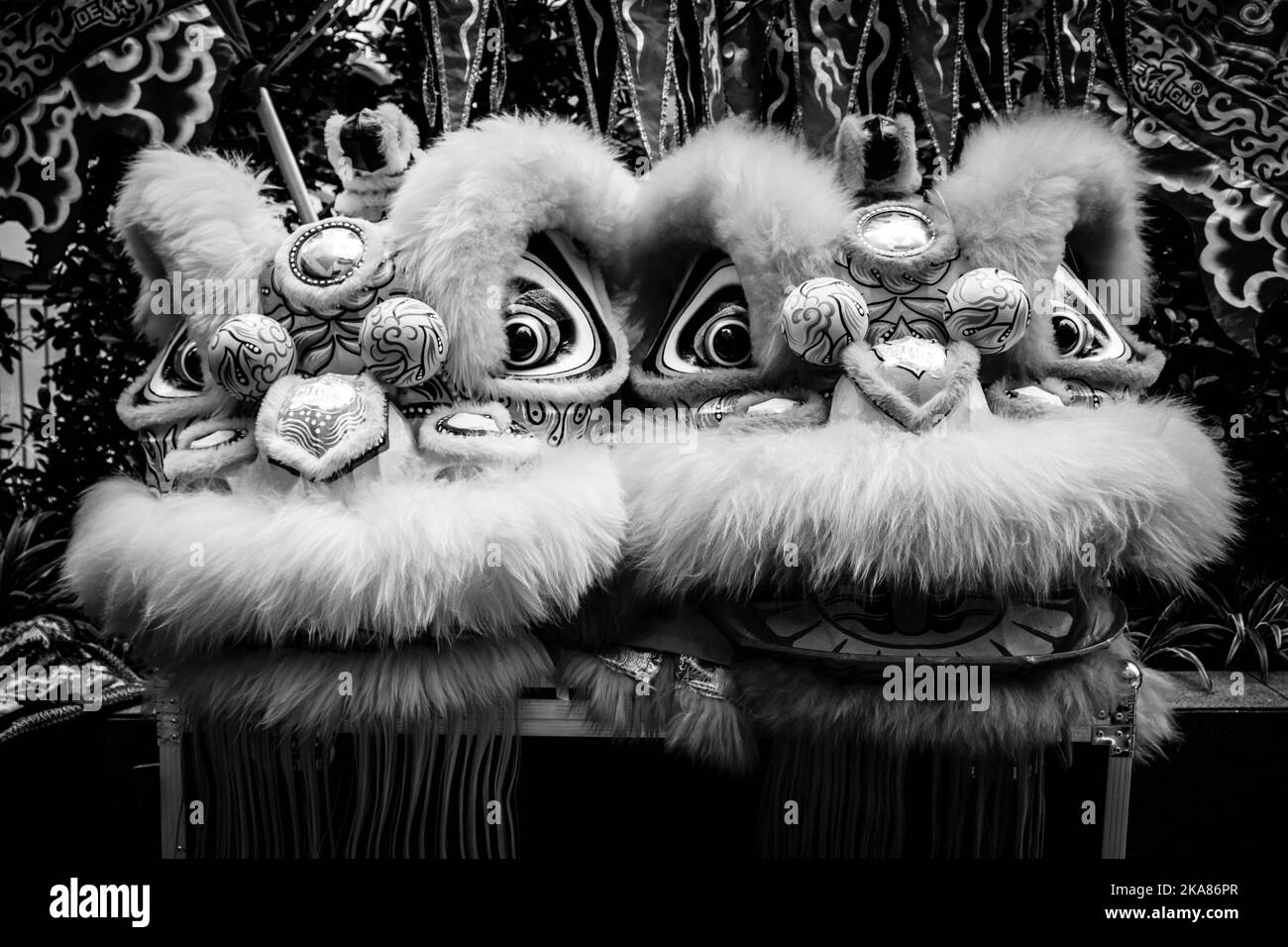 A greyscale shot of two lion dancers Stock Photo
