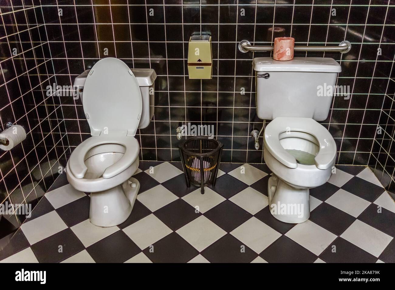 Public restroom with two toilets side by side, an unusual and humorous sight. Stock Photo