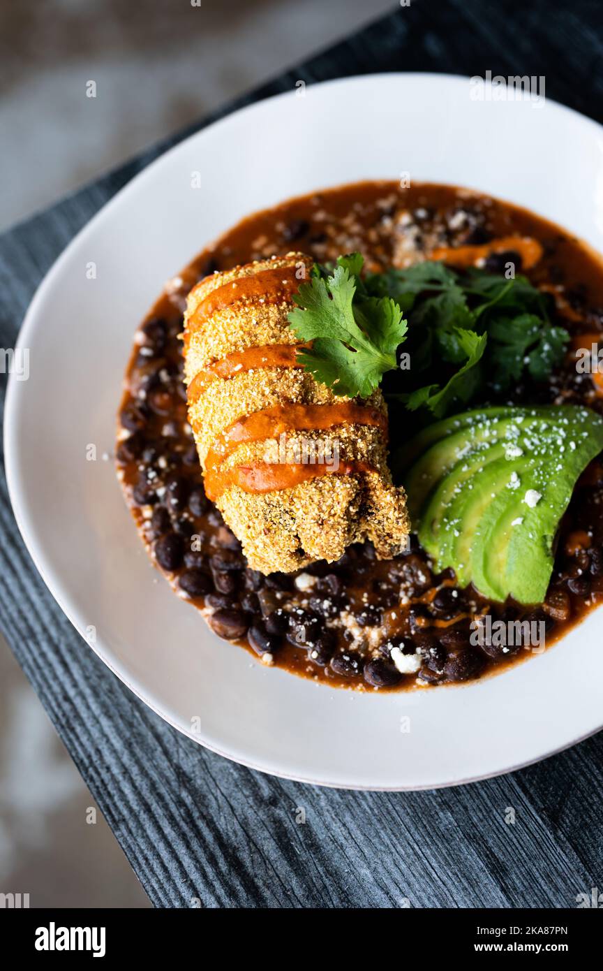 A chile relleno with avocado, black beans and cilantro Stock Photo Alamy