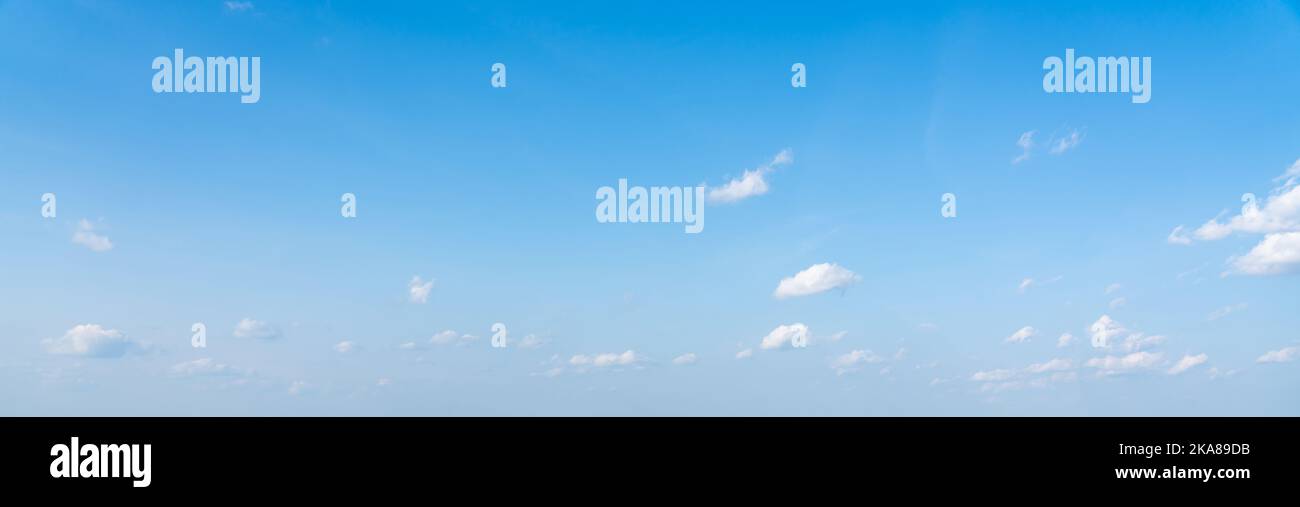 Blue panoramic sky background with small white clouds Stock Photo