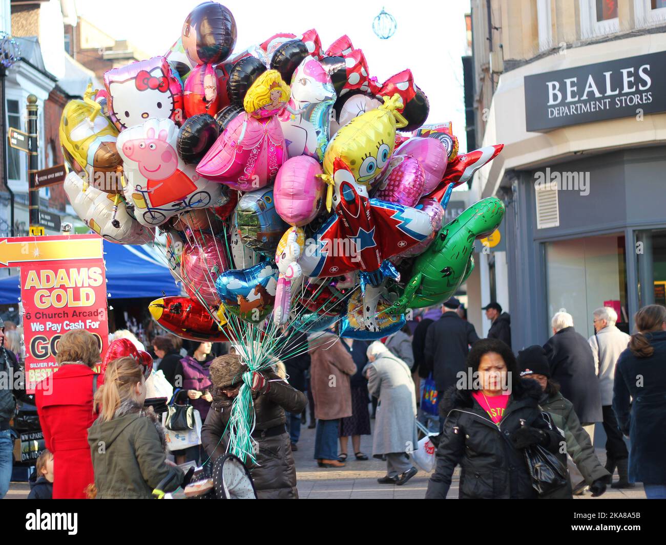 Balloon seller selling various balloons in Bedford town Centre, United Kingdom. Stock Photo
