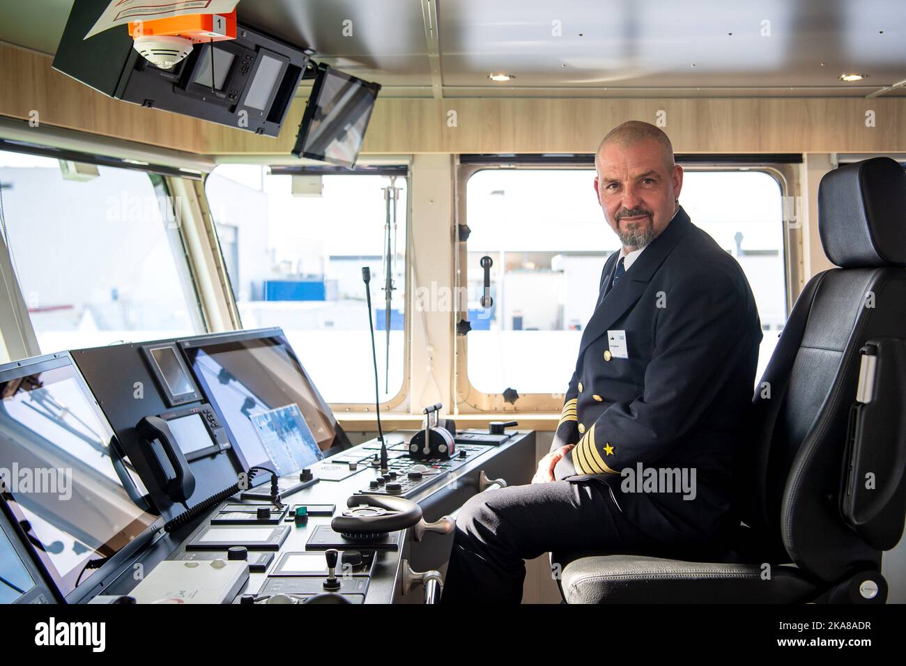 Berne, Germany. 01st Nov, 2022. Silvio Neugebauer, captain of the new research vessel 'Uthörn,' sits on the ship's bridge. The new 'Uthörn' replaces the research cutter of the same name commissioned in 1982. The newbuilding is to be the world's first seagoing vessel with an environmentally friendly and sustainable methanol propulsion system and will be used by the Alfred Wegener Institute (AWI). Credit: Sina Schuldt/dpa/Alamy Live News Stock Photo