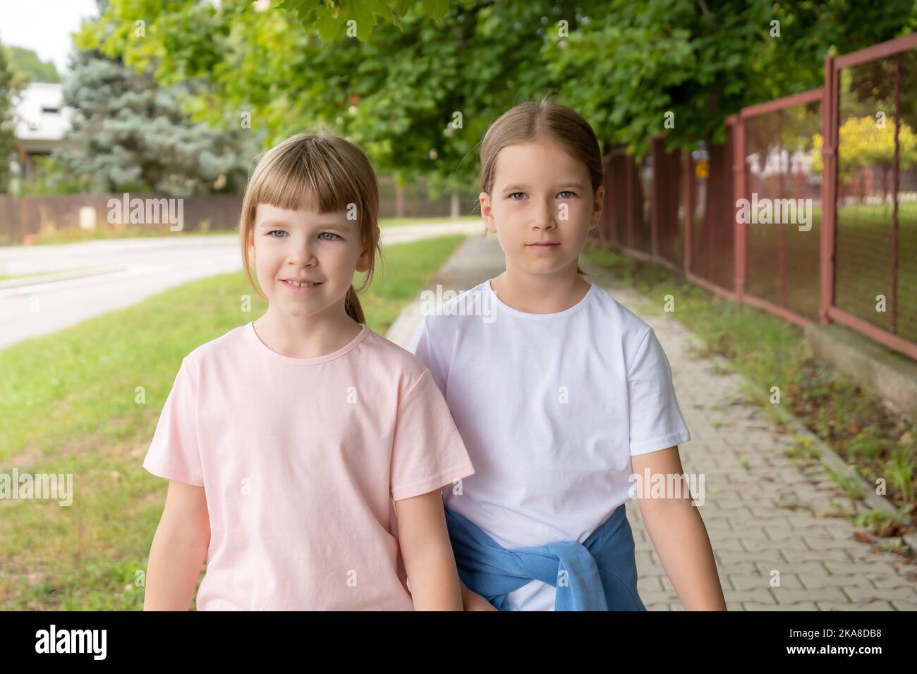 Two girls walking down street hi-res stock photography and images - Alamy