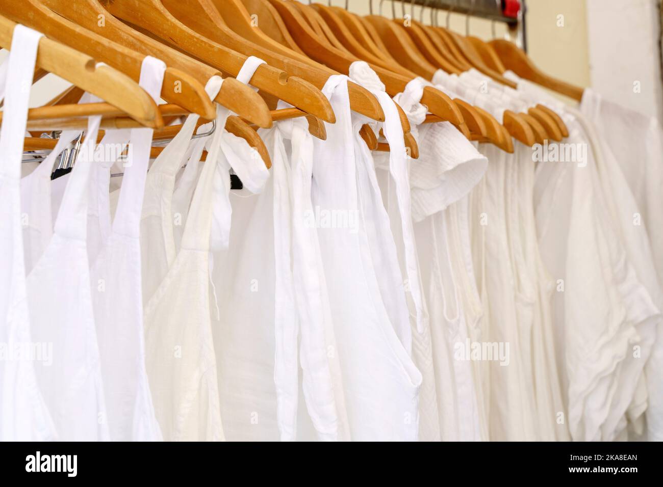 Organic eco clothes on a hanger. Home-made white clothing from natural and processed fabrics, natural vegetable ingredients. Eco-friendly dresses and shirts. High quality photo Stock Photo