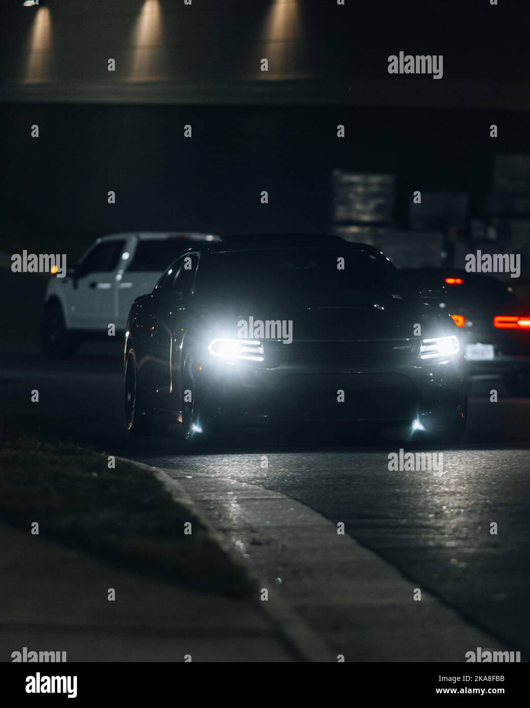 A car with headlights shining in the darkness Stock Photo - Alamy