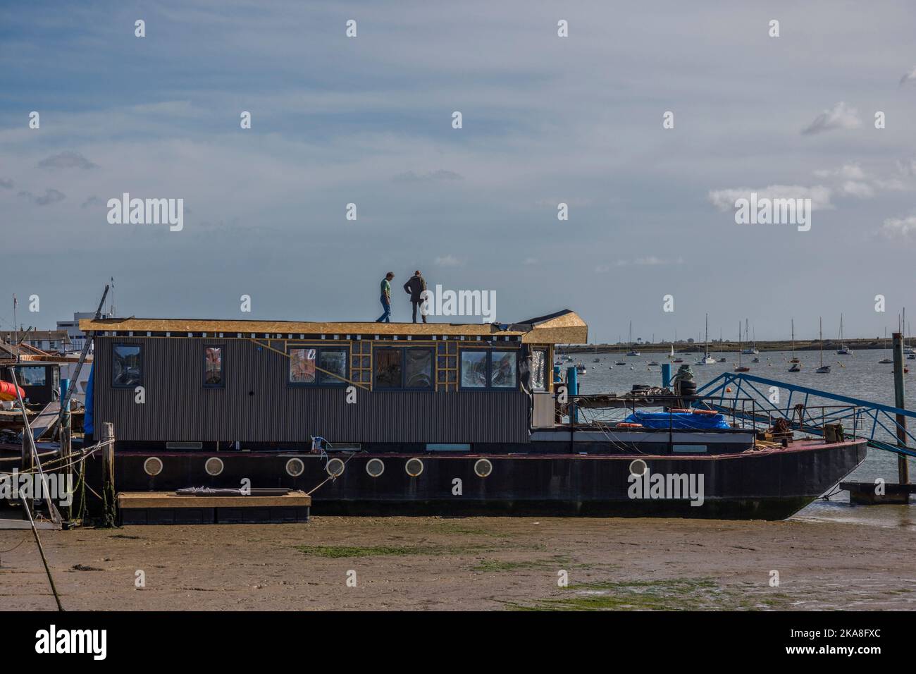two people renovating old boat at Burnham on Crouch. Stock Photo