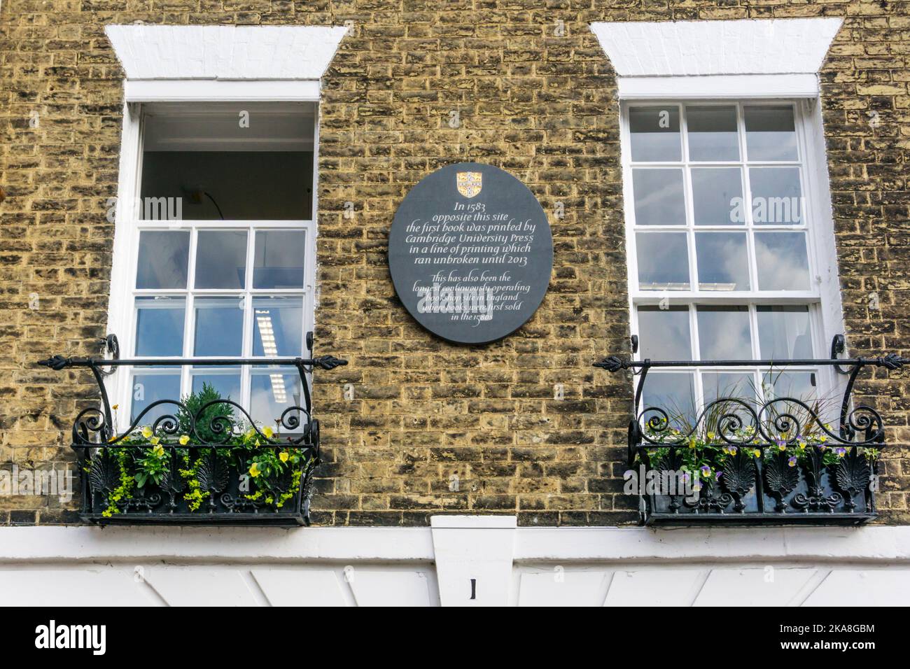 A plaque in Trinity Street, Cambridge, marks the nearby first location of the Cambridge University Press in 1583. Stock Photo