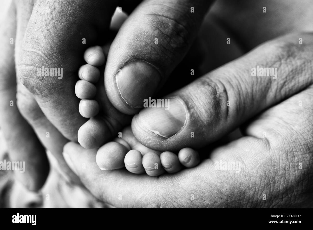 Mother is doing massage on her baby foot. Prevention of flat feet, development, muscle tone, dysplasia.  Stock Photo