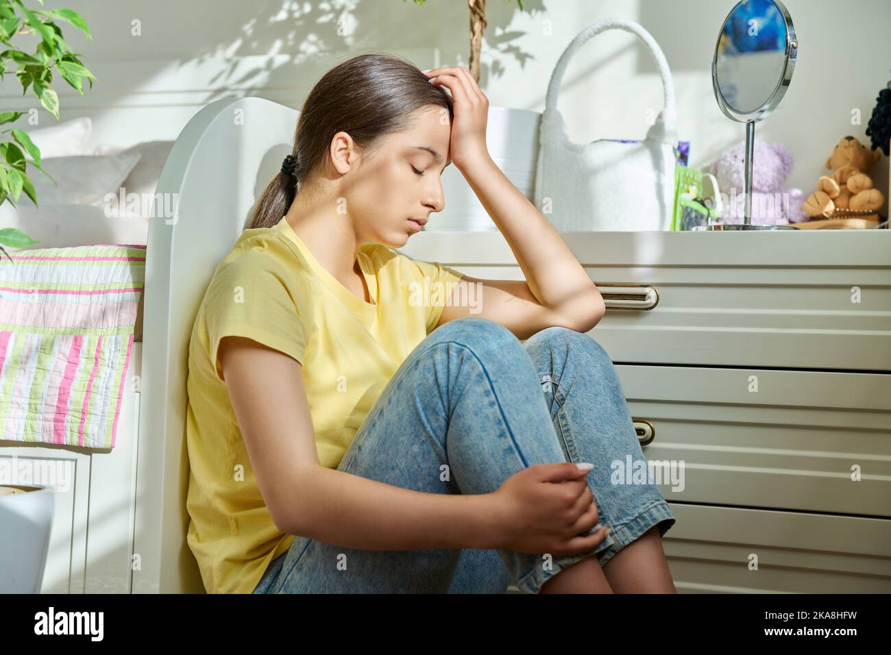 Sad teenage girl sitting on the floor at home Stock Photo - Alamy