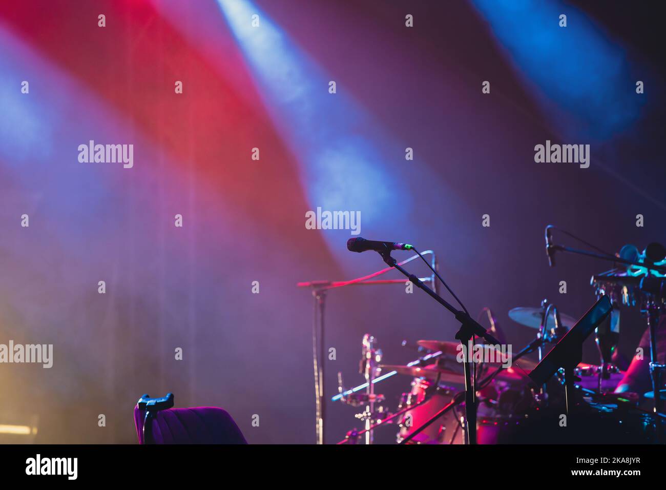 Microphone in colored spotlights and smoke. Concert and theatre scene Stock Photo