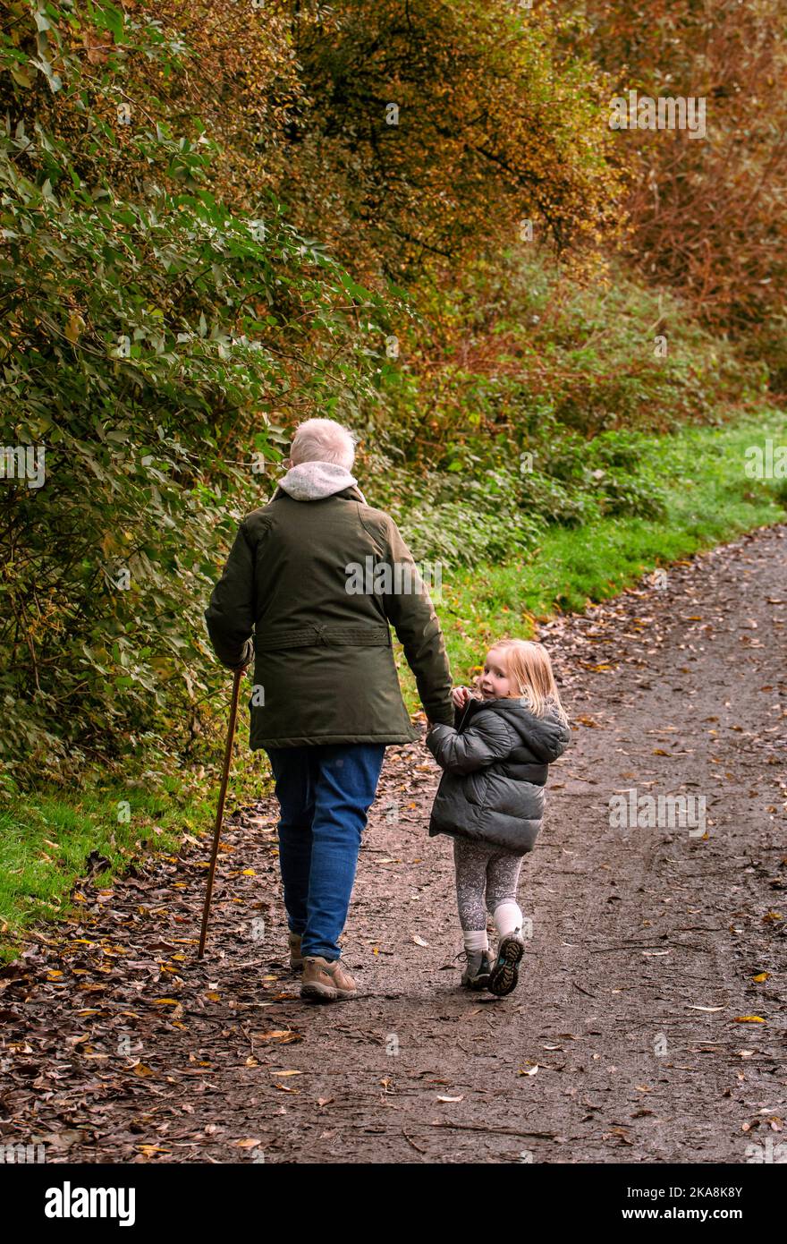 old people walking with young child Stock Photo