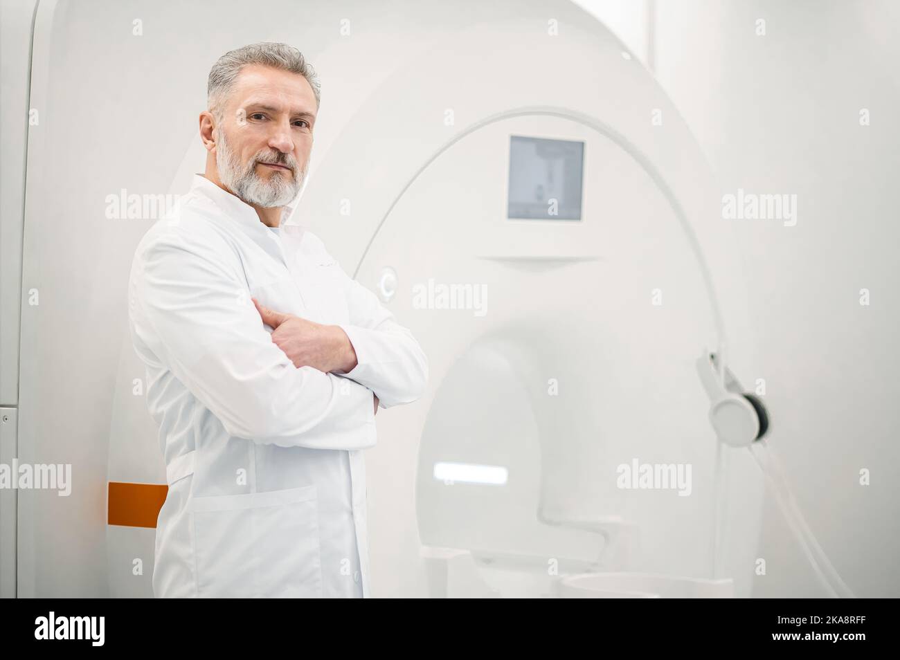 Male gray-haired doctor in a lab coat Stock Photo