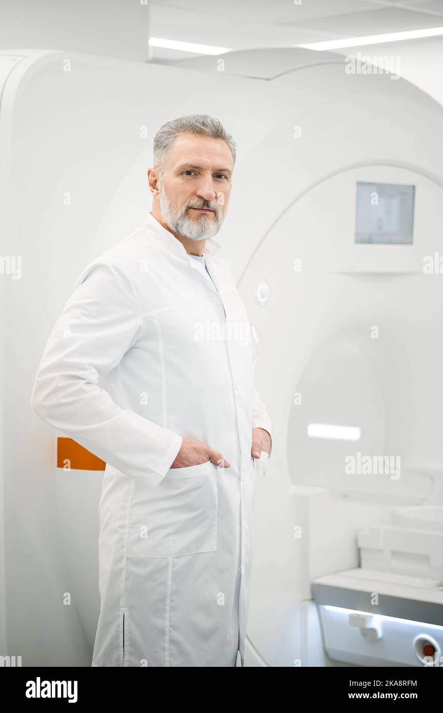 Male gray-haired doctor in a lab coat Stock Photo