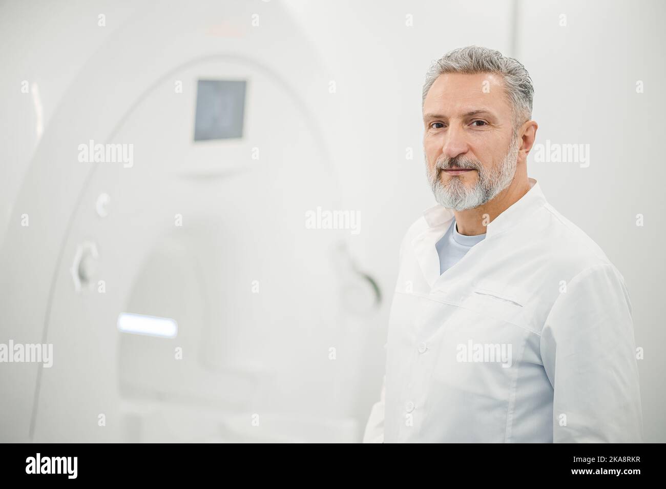 Male gray-haired doctor in a lab coat Stock Photo