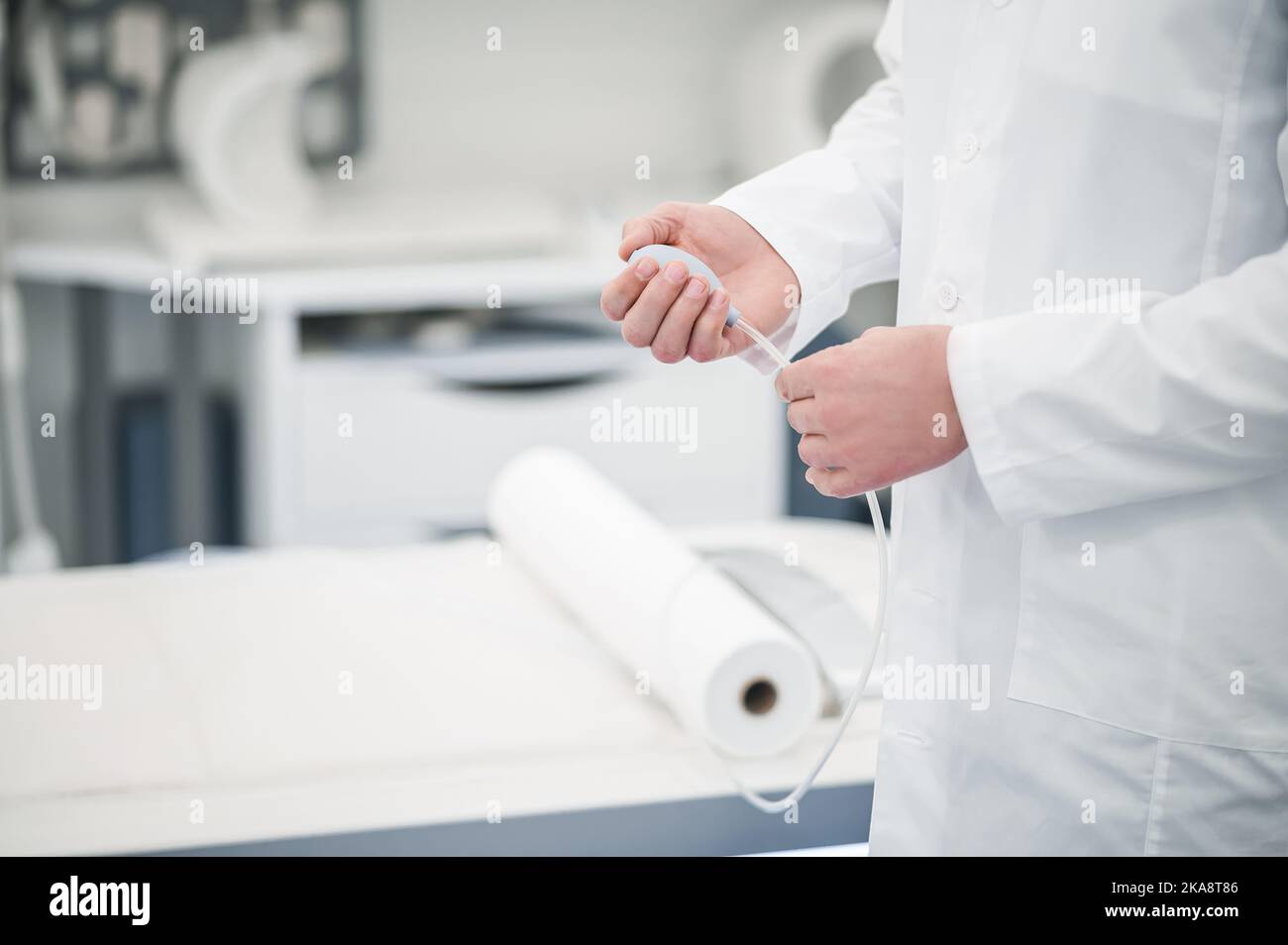 Male gray-haired doctor in a lab coat working in diagnostic center Stock Photo