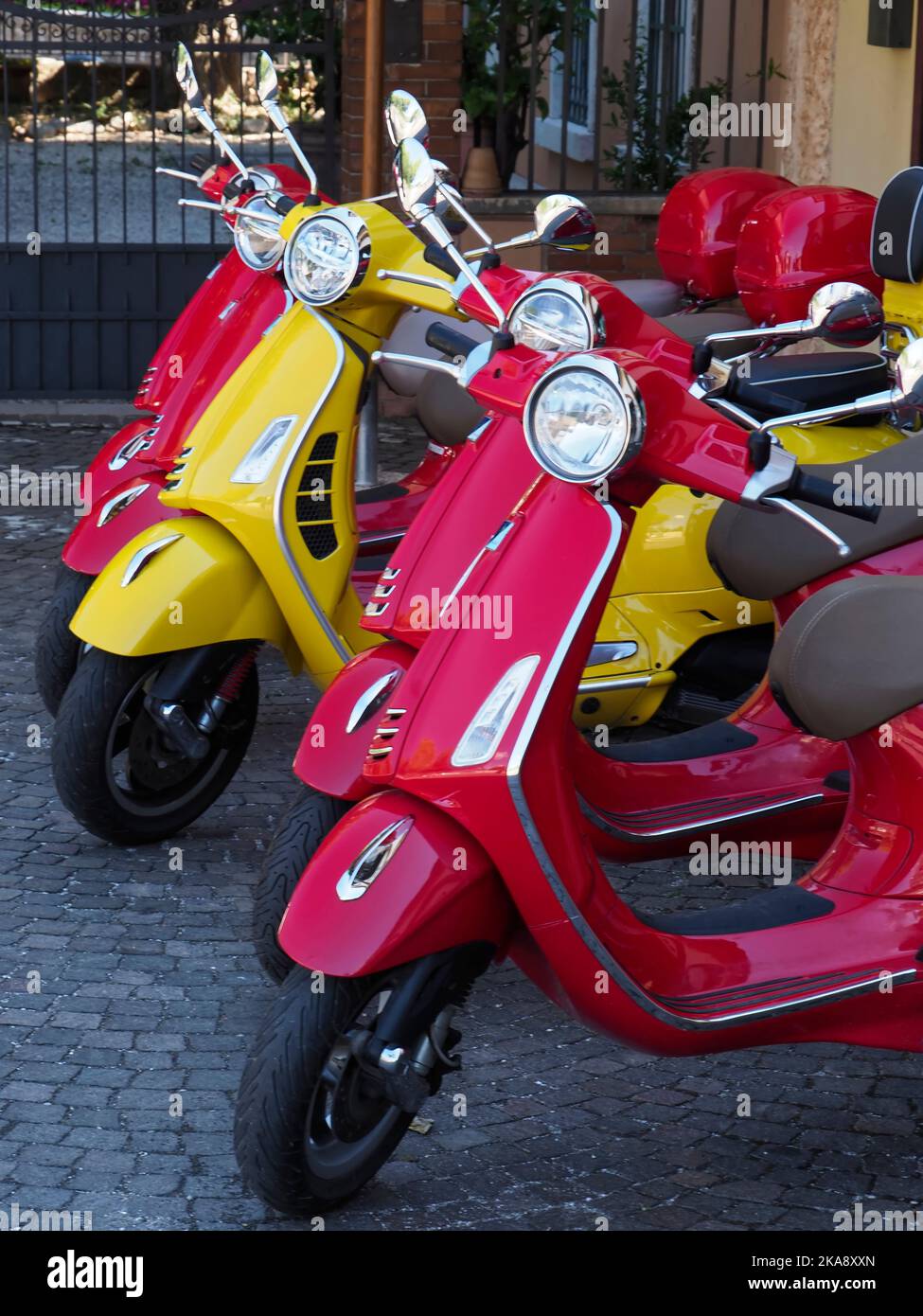 colourful red and yellow vespa scooters for hire, Lazise, Lake Garda