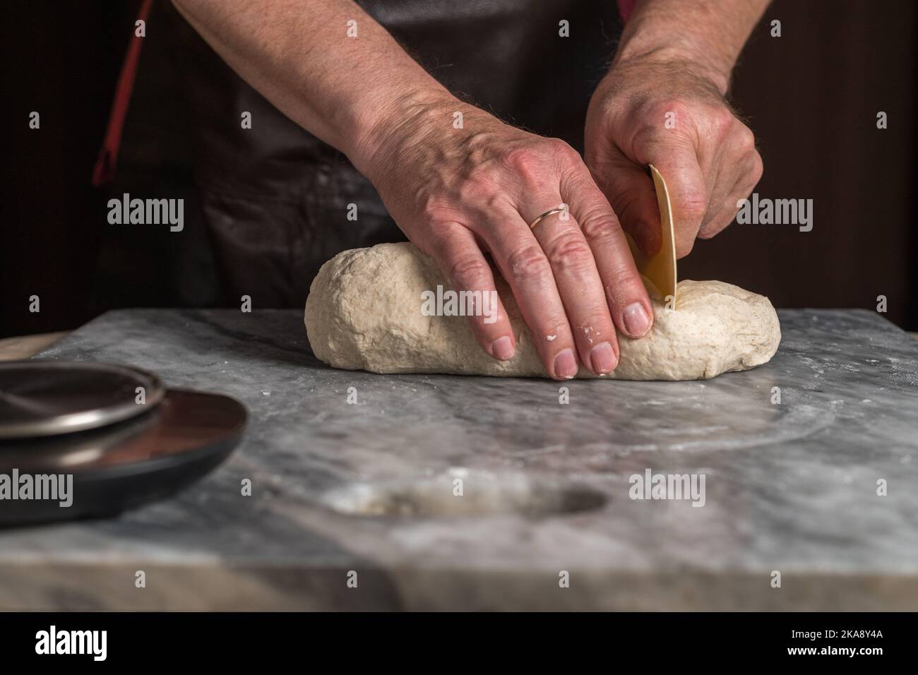 Man preparing pizza, dough on marble table. Stock Photo