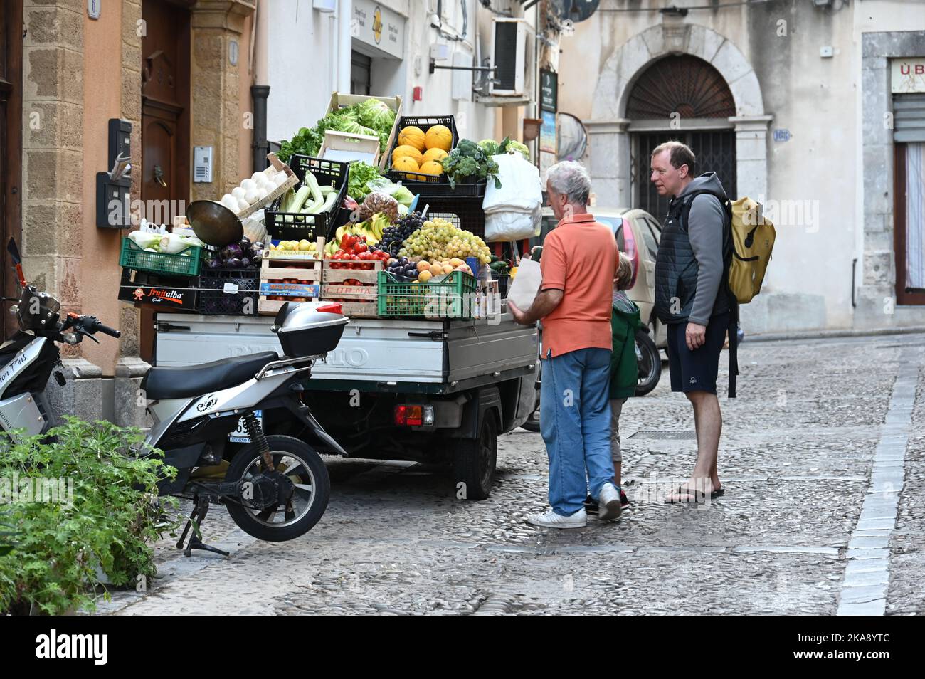 Selling fruit and vegetables on the streets of Cefalu, Sicily Stock Photo