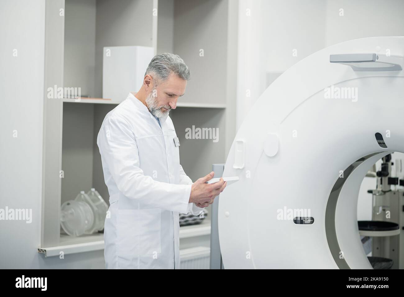 Mature radiologist standing near hi-res stock photography and images ...