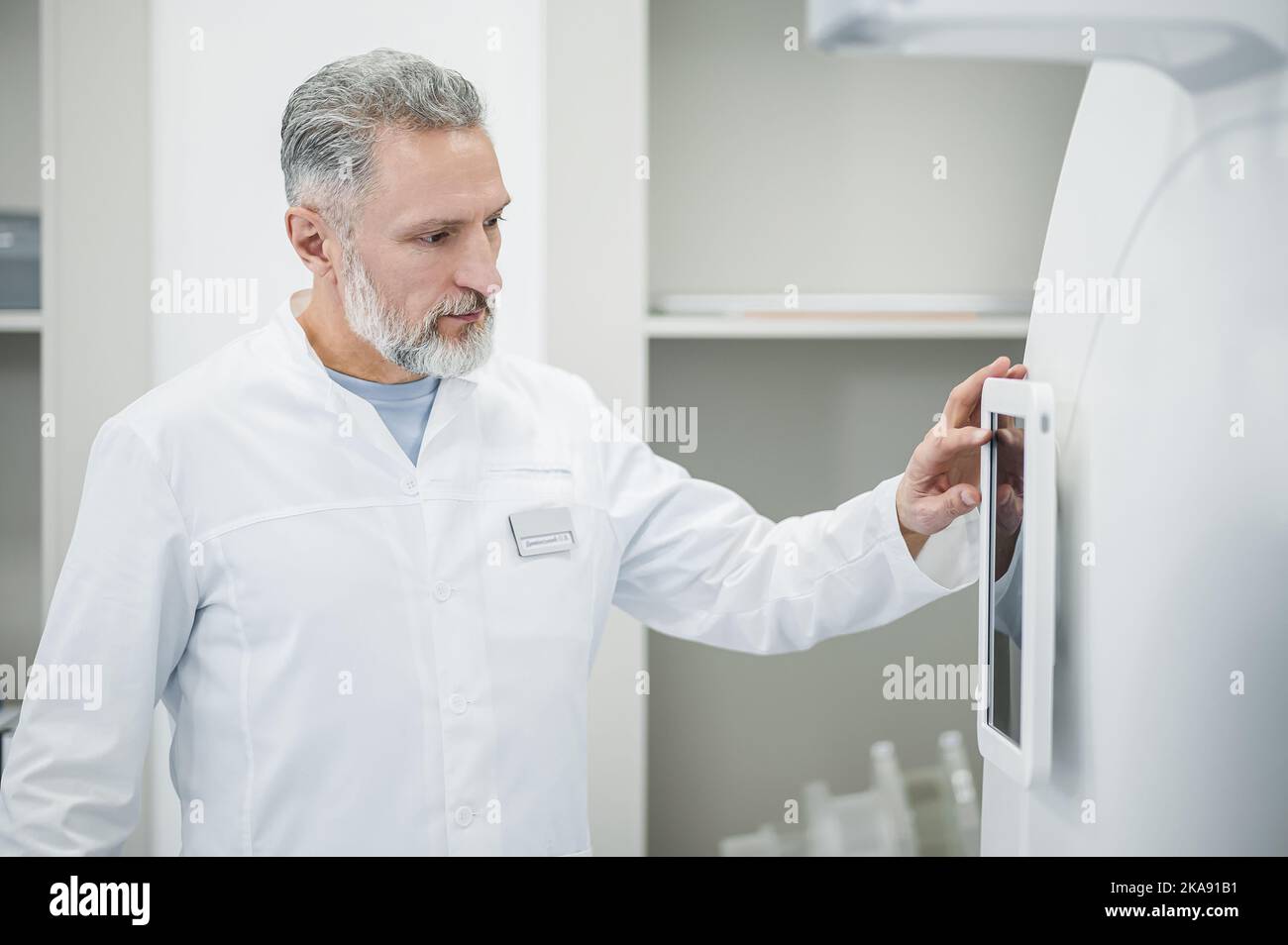 Mature radiologist standing near hi-res stock photography and images ...