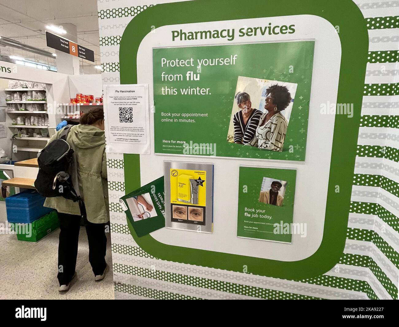 Pharmacy services and flu vaccine signs inside Sainsburys, Wandsworth
