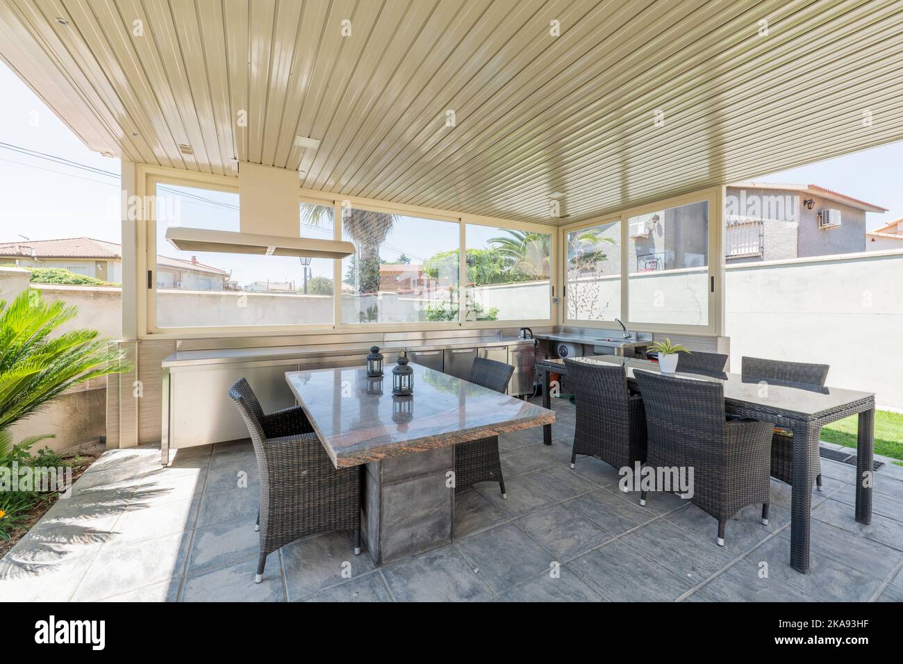 Gazebo with metal roof, rattan tables and chairs and metal furniture