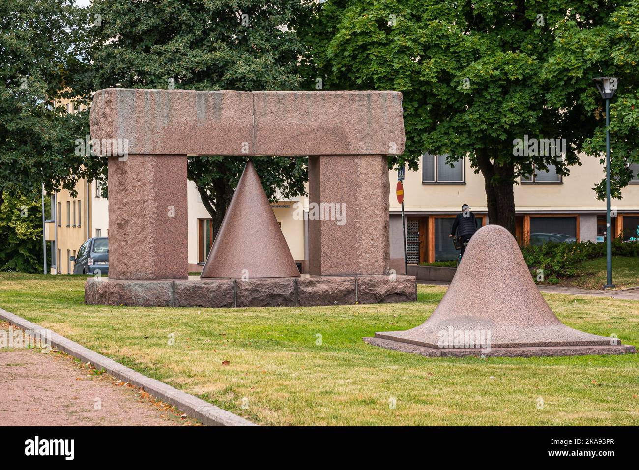 Finland, Kotka - July 18, 2022: Geometric marble statues set on green lawn outside cty library. Green foliage above. Stock Photo