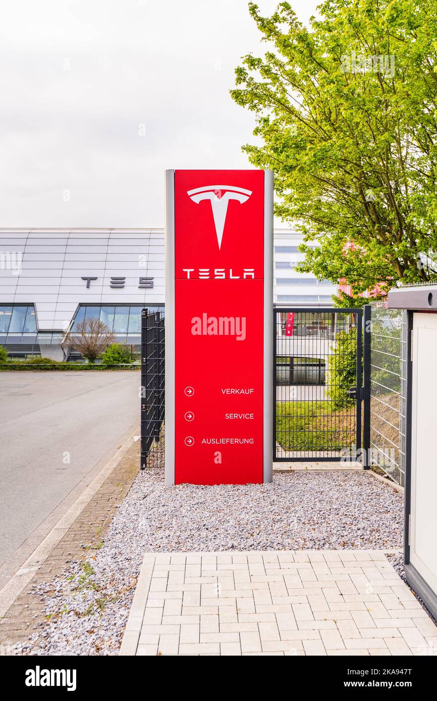 Tesla logo at the Tesla service center with a visible hall behind it