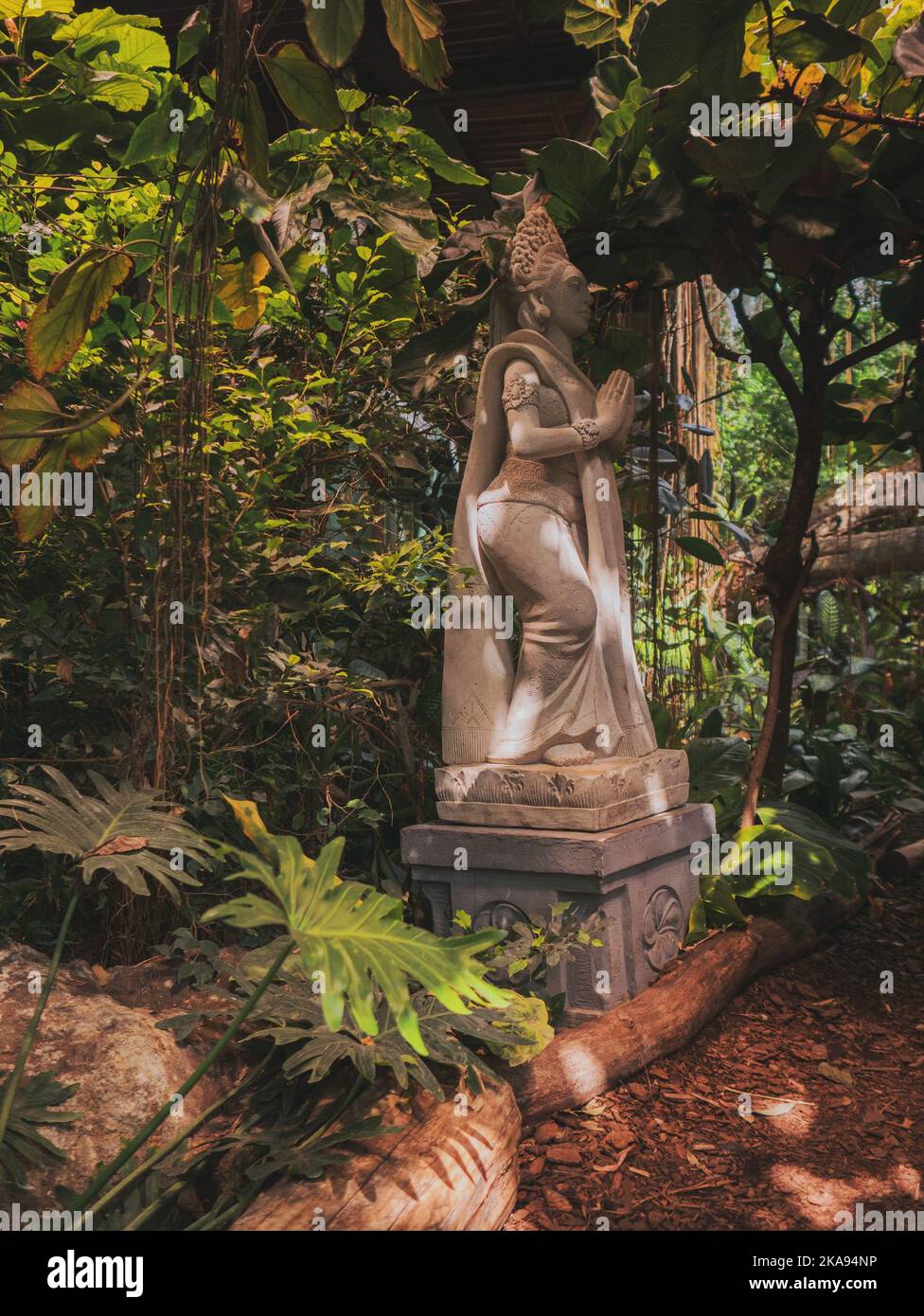 Praying Statue made of stone with dots of light Stock Photo Alamy
