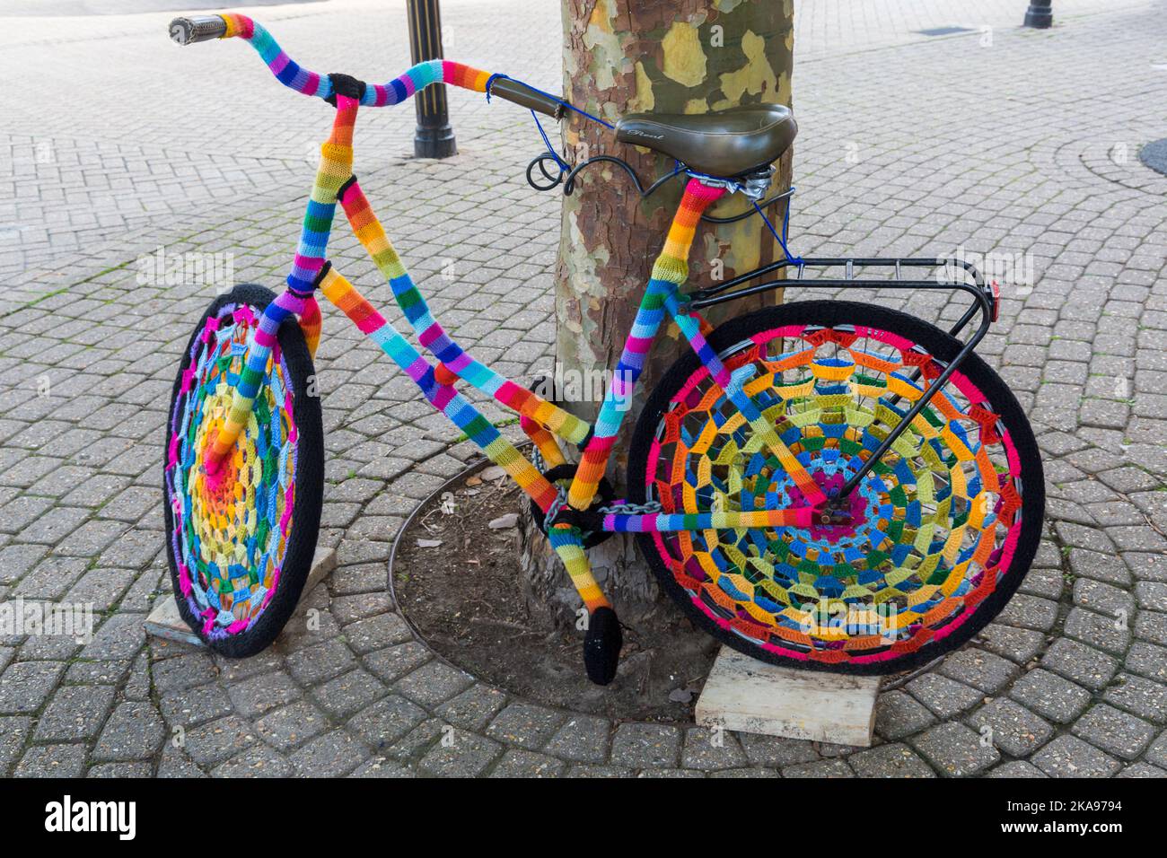 Colourful yarn bombing bike, yarn bomb crochet crocheted bike against