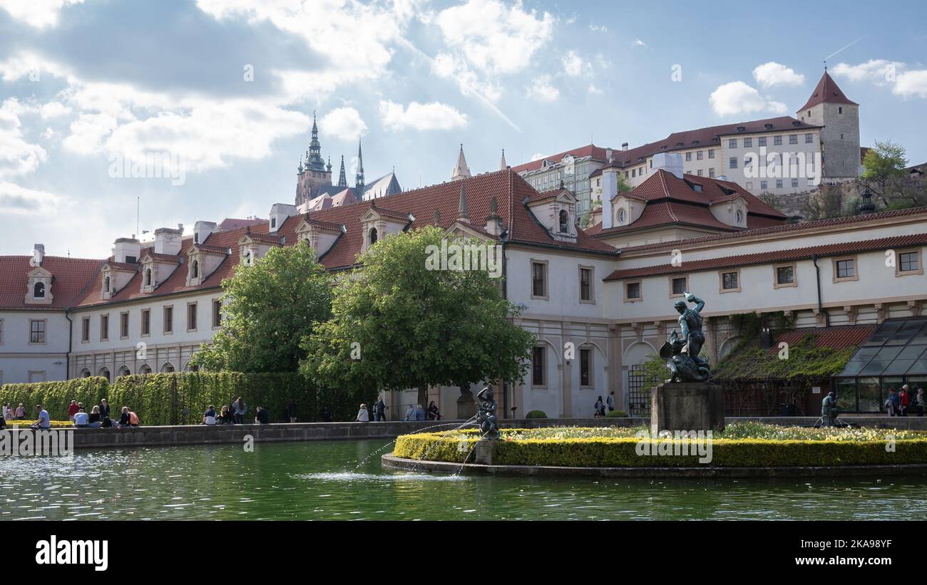 Beautiful historic garden with fountain, pool and castle towering above it, Prague, Czechia Stock Photo