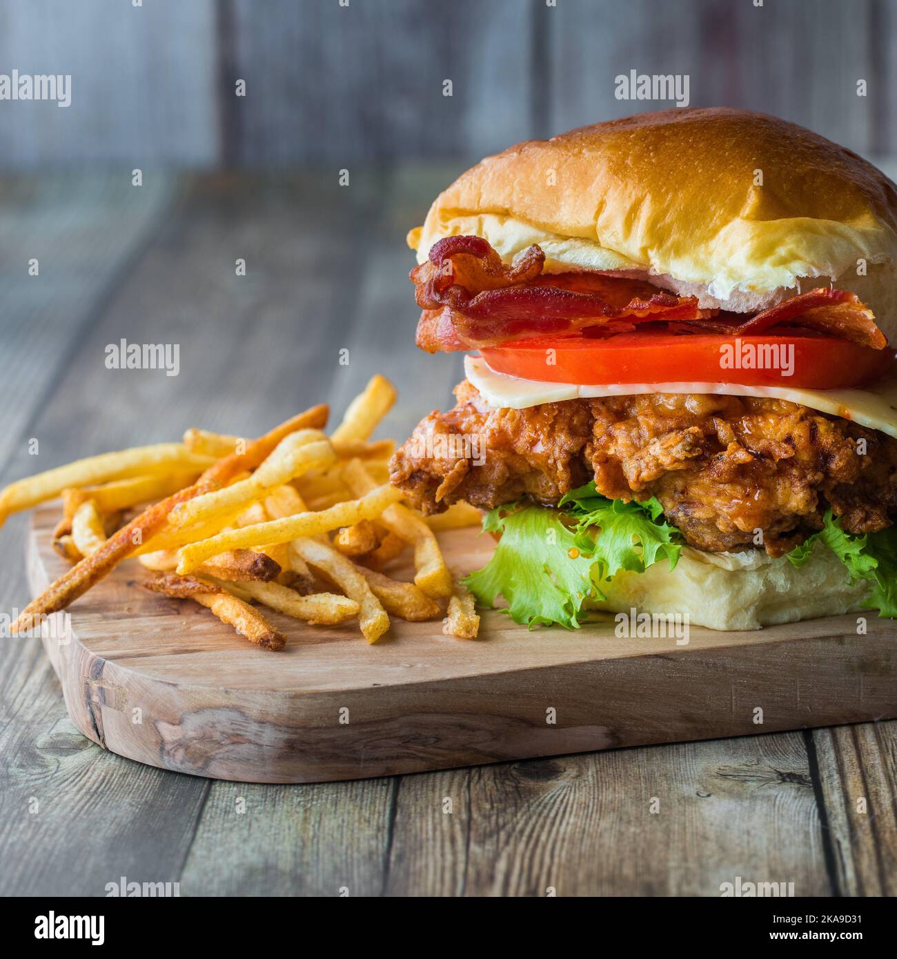 A close up of a homemade fried chicken sandwich served with shoestring
