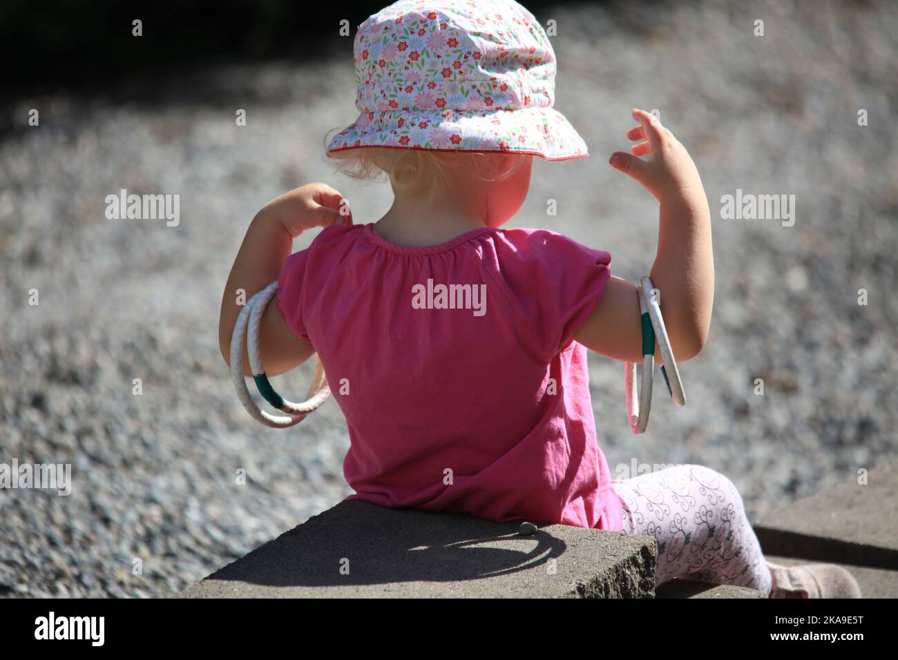 Little girl playing with rings Stock Photo - Alamy