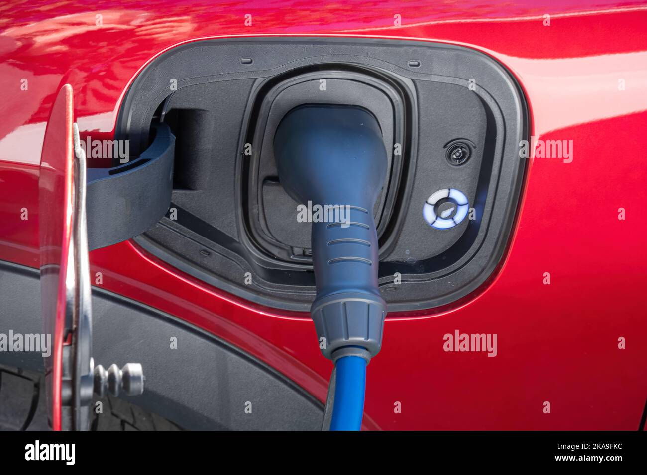 Close up of the power supply plugged into an electric car being charged