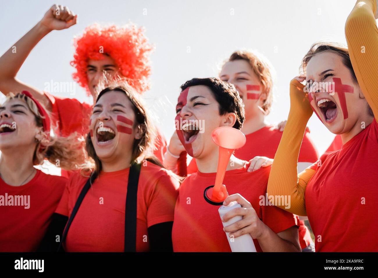Red sport football fans celebrating team victory in championship game