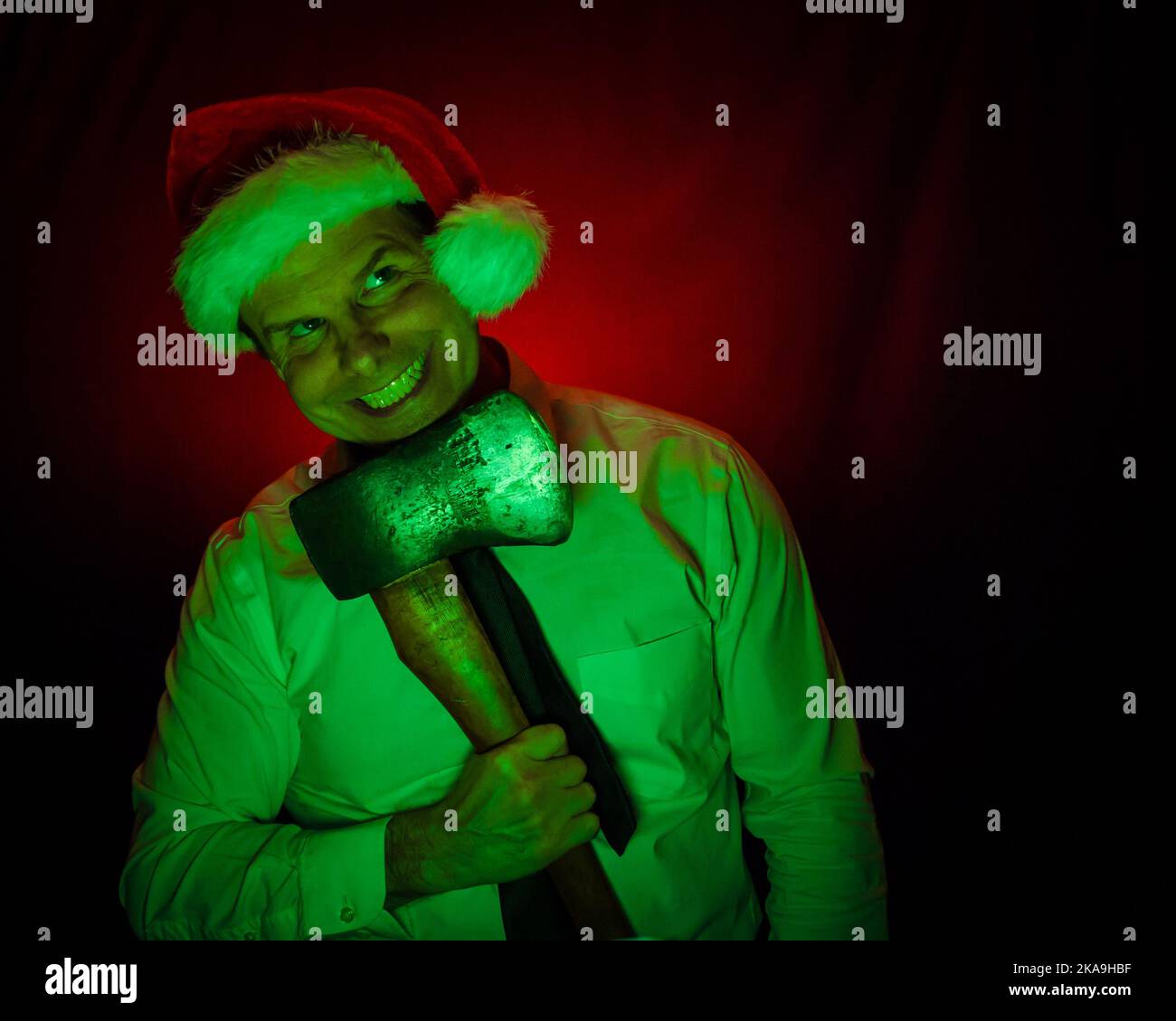 Portrait of Man Wearing Christmas Stocking Hat and Holding an Axe. Halloween and Christmas Horror Concept. Stock Photo