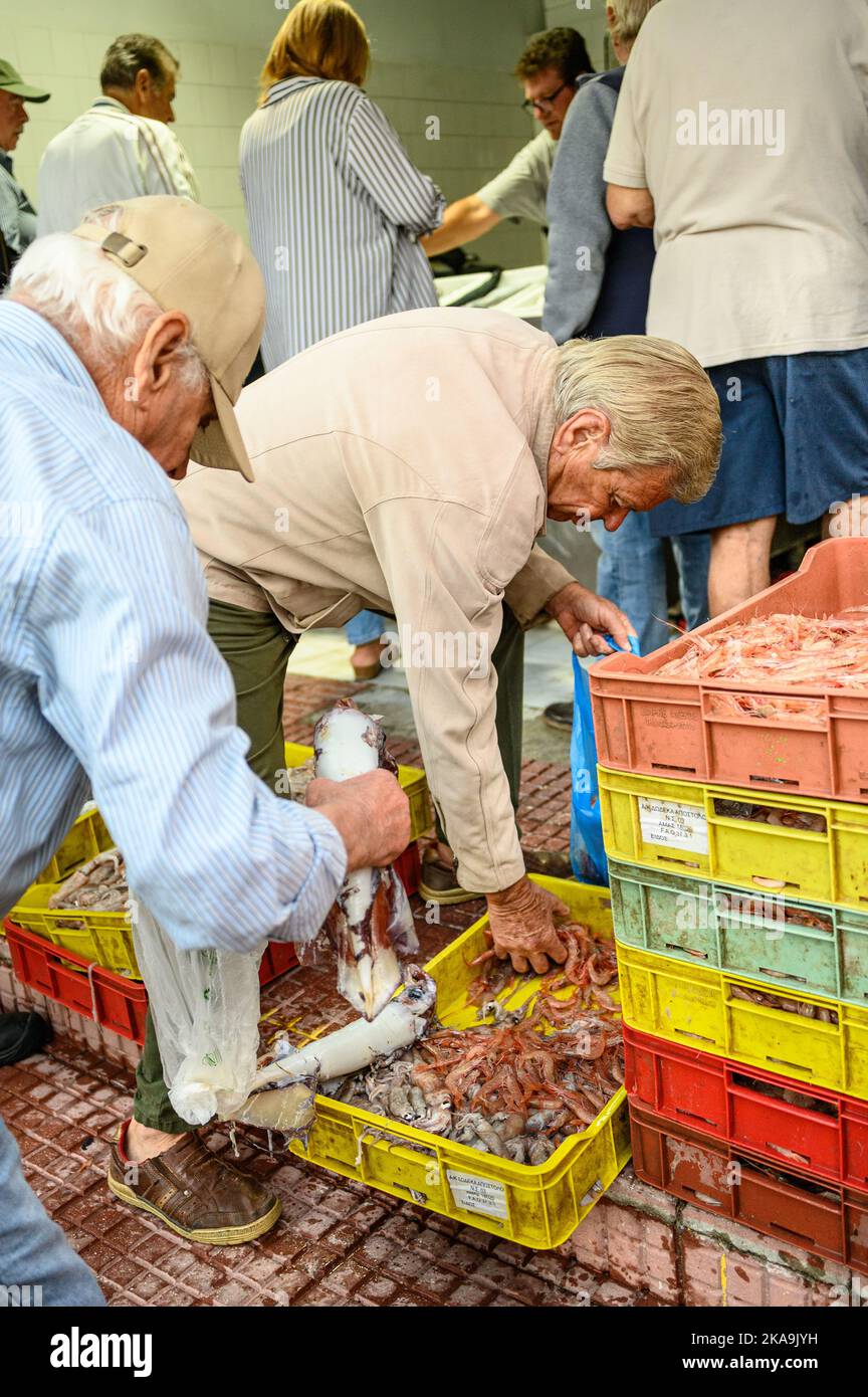 Buying fish at the fish market.Skiathos island Greece. Stock Photo