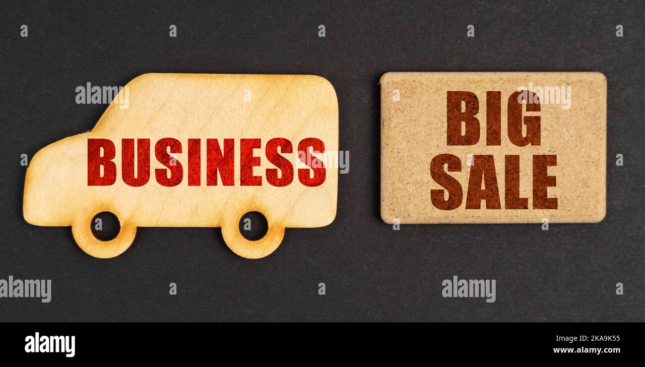 Business concept. On a black background, a car - business and a sign with the inscription - BIG SALE Stock Photo