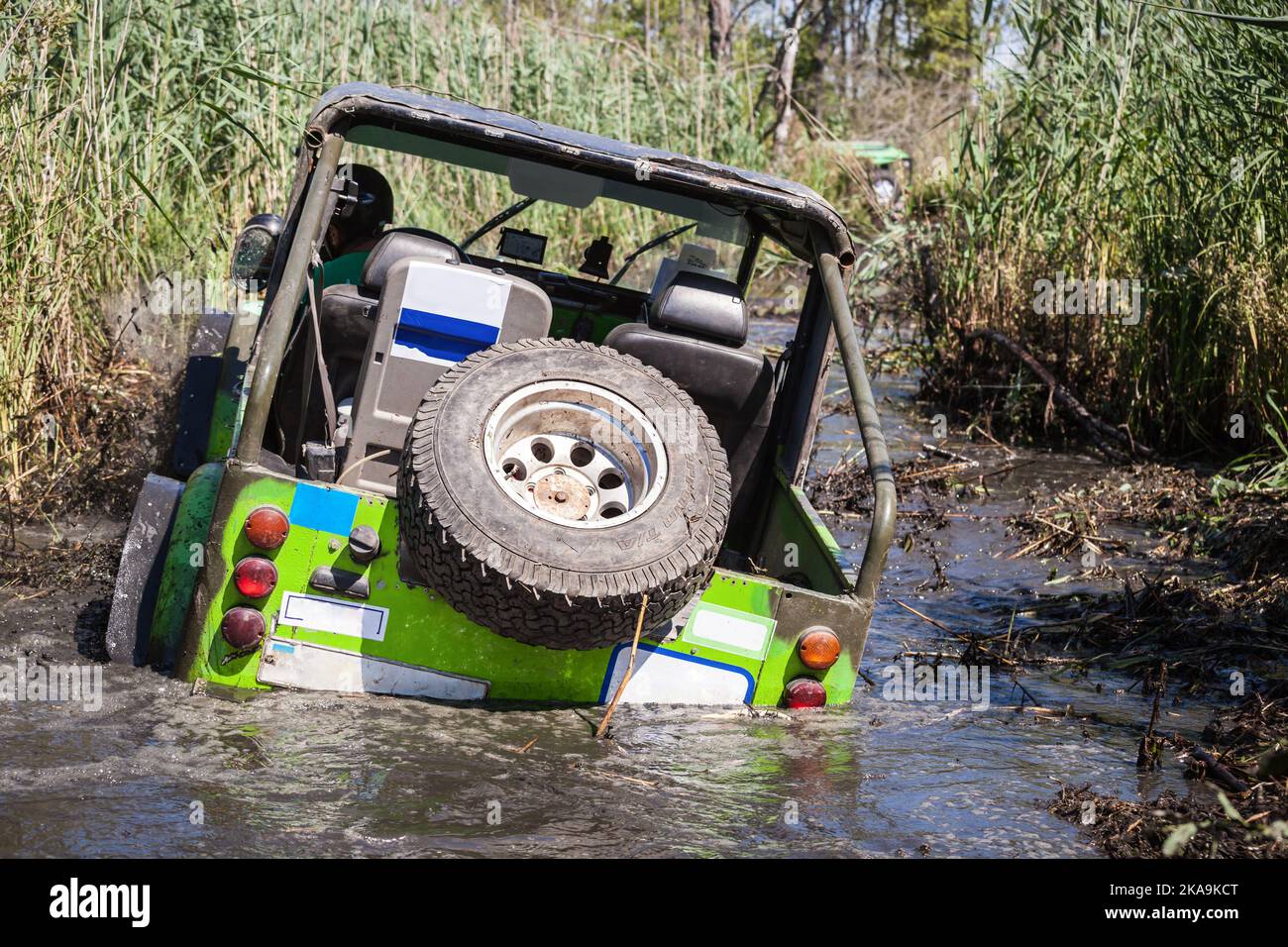 Off-road car overcoming a swampy area. Stock Photo