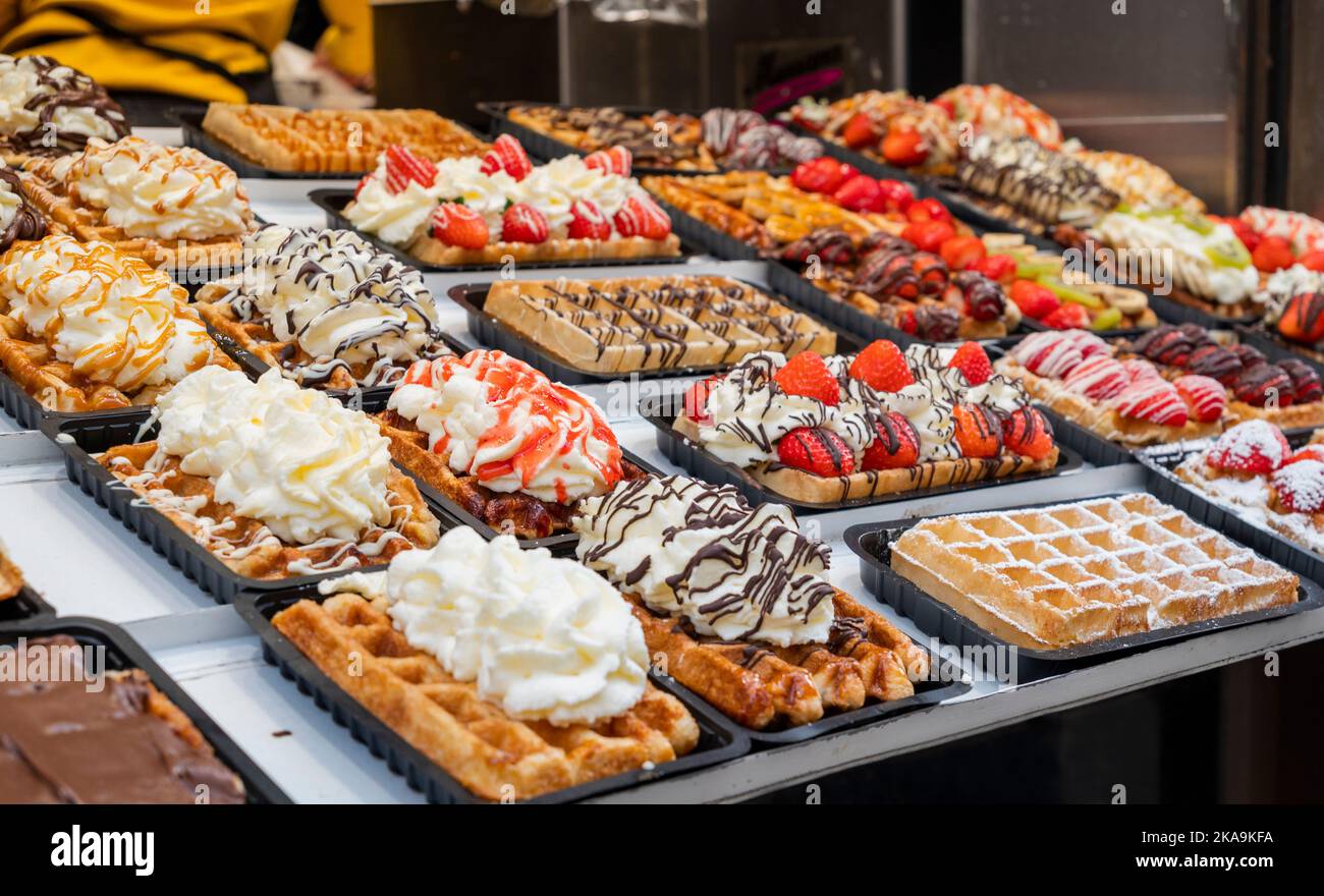 national food waffles in Belgium on the square in pastry shops with chocolate cream and berries Stock Photo