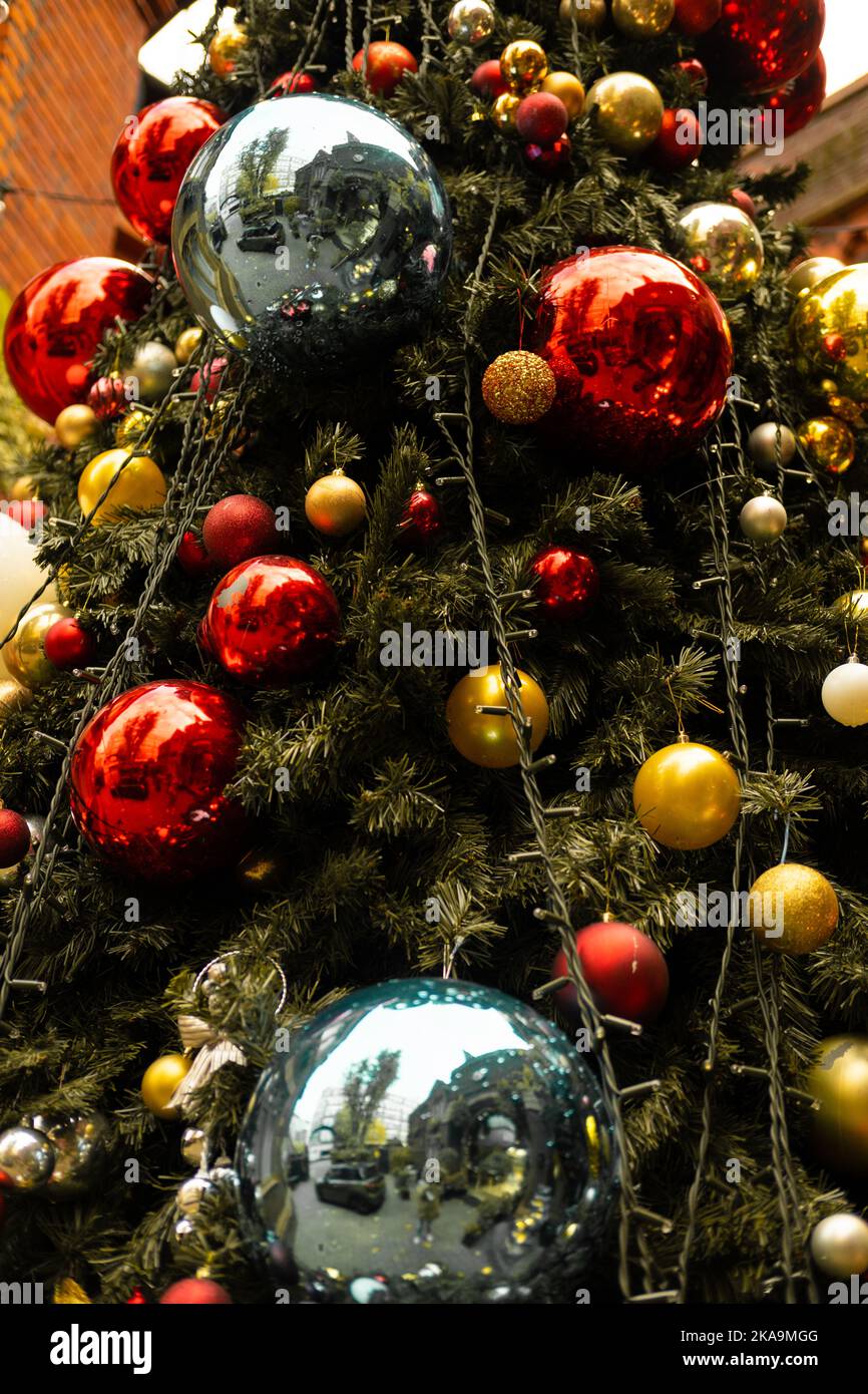 Vertical partial view of a decorated Christmas tree outdoors Stock Photo