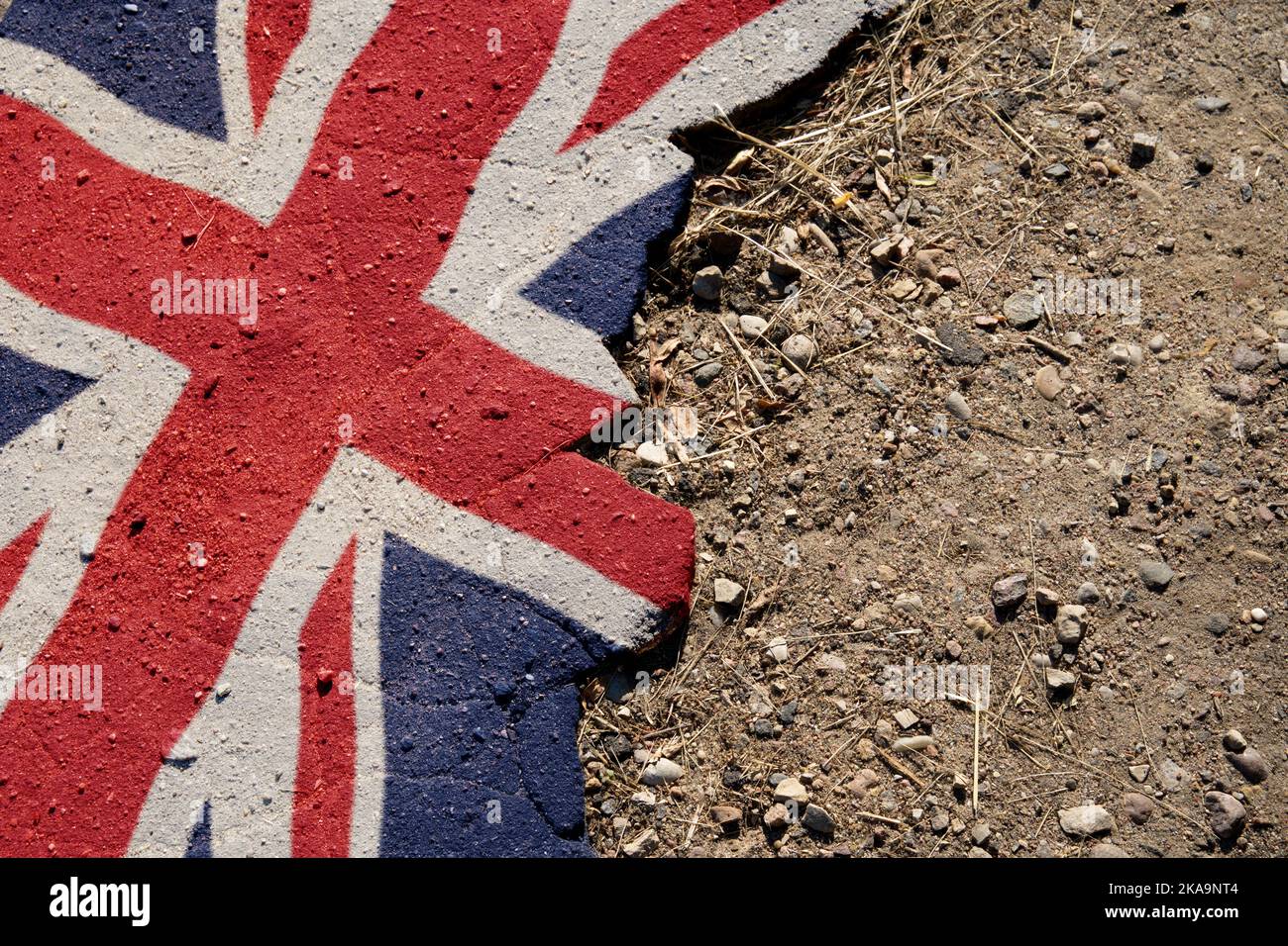Business and politics concept. A crisis. Flag on the broken asphalt - Great Britain Stock Photo