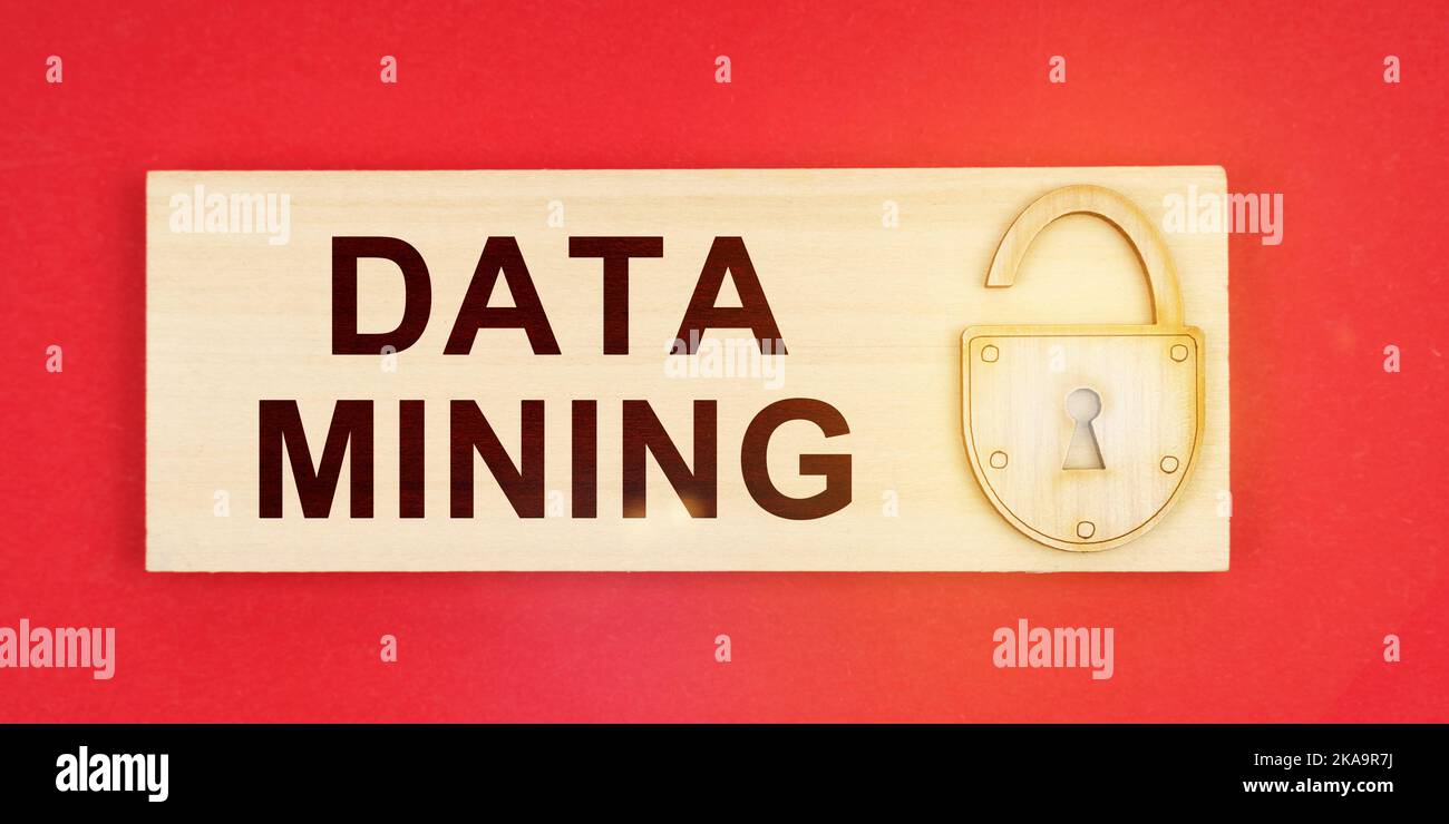 Business concept. On a red background there is a small plaque on it with a lock and an inscription - DATA MINING Stock Photo