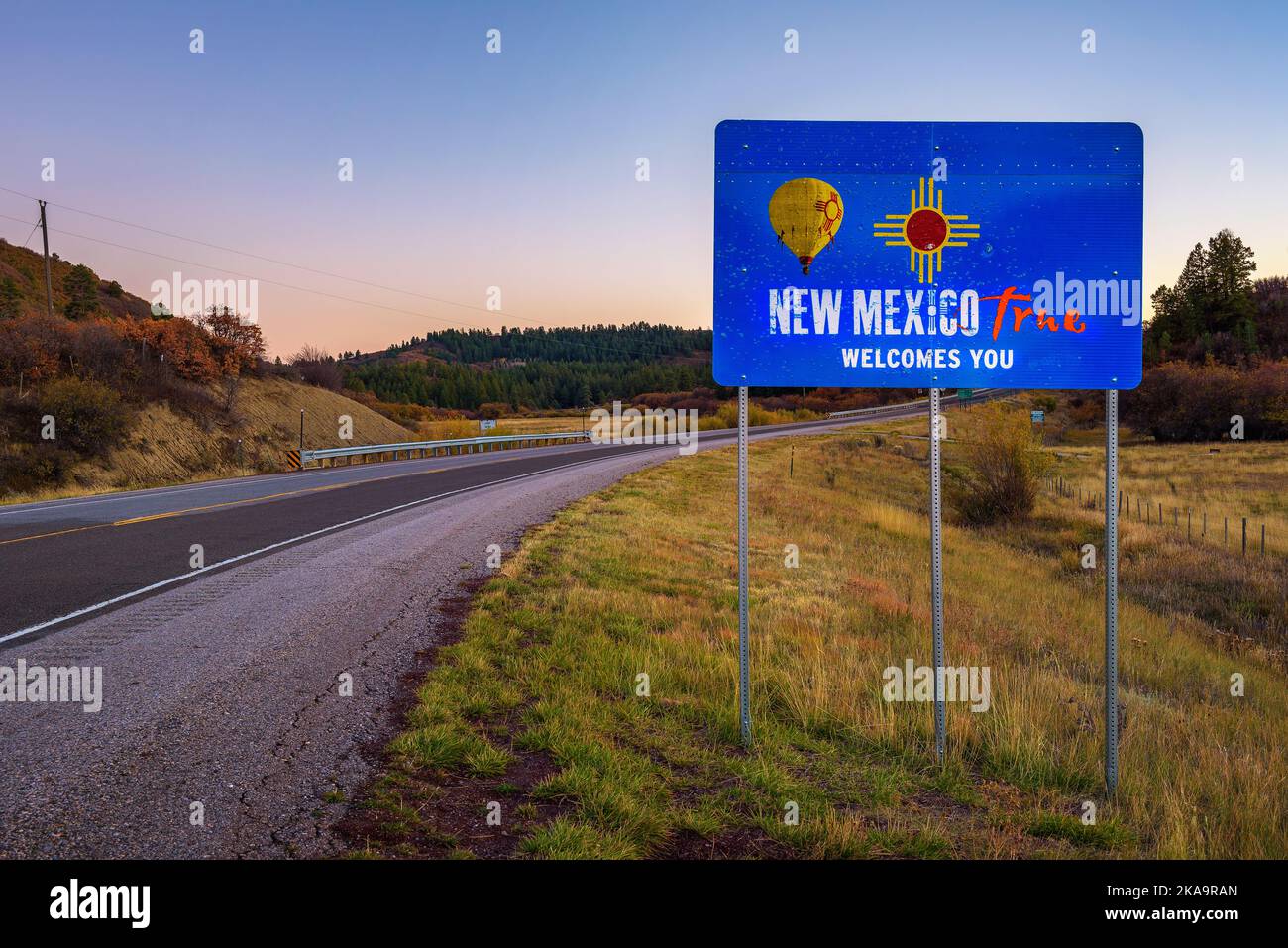 New Mexico Welcomes You street sign situated along a country road Stock Photo