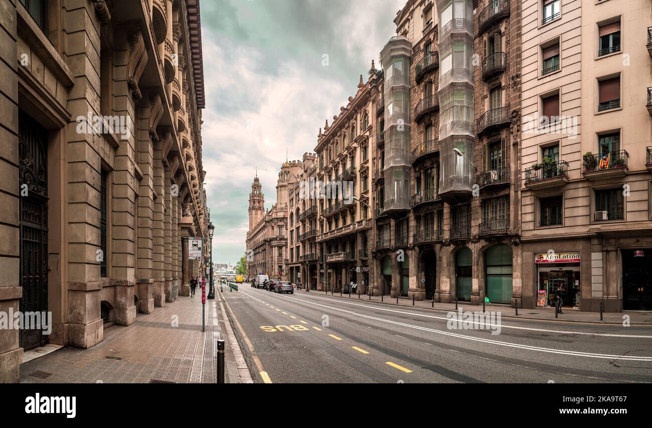 Street Photo of Via Laietana in Barcelona, Spain showing architecture and morning traffic in a cloudy day. Stock Photo